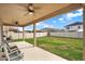 Inviting covered patio with ceiling fans, comfortable seating, and serene backyard views at 3460 Canvas St, Kissimmee, FL 34741