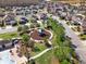 A high angle, aerial photo shows a charming neighborhood playground with mature landscaping at 3460 Canvas St, Kissimmee, FL 34741