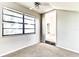 Carpeted bedroom featuring a large window and an open doorway at 3544 Raintree Cir, Lakeland, FL 33803