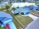 An aerial view of the property with a view of the roof and surrounding houses near a pond at 3719 Imperial Dr, Winter Haven, FL 33880