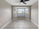 Empty room with a tiled floor, neutral walls, and a bay window at 3719 Imperial Dr, Winter Haven, FL 33880
