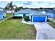 Charming single-story home featuring a well-maintained lawn, blue accents, and an attached garage at 3719 Imperial Dr, Winter Haven, FL 33880