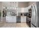 Bright kitchen featuring white cabinets, stainless steel appliances, granite countertops, and modern lighting at 3719 Imperial Dr, Winter Haven, FL 33880