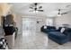 Bright living room featuring tile floors, a sliding glass door, and a cozy blue sectional at 3719 Imperial Dr, Winter Haven, FL 33880