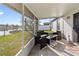 Cozy screened-in porch with stylish outdoor furniture and a view of the backyard at 3719 Imperial Dr, Winter Haven, FL 33880
