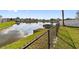 Picturesque view of the waterfront with a chain link fence that provides safety and security at 3719 Imperial Dr, Winter Haven, FL 33880