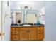 Well-lit bathroom featuring an oak vanity, a mirror, and decorative accents at 403 Saint Anns Dr, Winter Haven, FL 33884