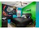 Cozy bedroom with a ceiling fan, black bed and colorful decorations at 403 Saint Anns Dr, Winter Haven, FL 33884