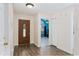 Inviting entryway with wood-look tile flooring and decorative front door at 403 Saint Anns Dr, Winter Haven, FL 33884