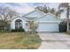 Charming single-story home with a well-maintained front yard and attached two-car garage, offering curb appeal at 403 Saint Anns Dr, Winter Haven, FL 33884