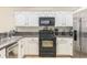 Updated kitchen featuring stainless steel appliances, ample cabinet space, and tile backsplash at 403 Saint Anns Dr, Winter Haven, FL 33884