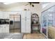Bright kitchen with stainless steel refrigerator, storage cabinets, and adjacent sunroom access at 403 Saint Anns Dr, Winter Haven, FL 33884