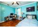Comfortable bedroom features hardwood floors, a ceiling fan, and ample natural light at 424 S Elm Rd, Lakeland, FL 33801
