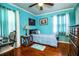 Bright bedroom with hardwood floors, a ceiling fan, and ample natural light at 424 S Elm Rd, Lakeland, FL 33801
