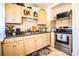 Functional kitchen featuring neutral-toned cabinets, stainless steel appliances, and ample countertop space at 424 S Elm Rd, Lakeland, FL 33801