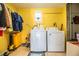 Well-lit laundry room with a new washer and dryer, storage and closet space, and room to organize clothing at 424 S Elm Rd, Lakeland, FL 33801