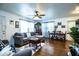 Spacious living room with hardwood floors, a ceiling fan, and natural light from the windows at 424 S Elm Rd, Lakeland, FL 33801