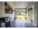 Relaxing covered patio with a grill and lattice offering a private space for relaxation or outdoor cooking at 424 S Elm Rd, Lakeland, FL 33801