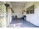 Covered patio with grill, seating, and lattice offering a private space for relaxation or outdoor cooking at 424 S Elm Rd, Lakeland, FL 33801