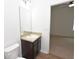 Bathroom with a single vanity, neutral countertop, and essential fixtures, conveniently located near the bedroom entrance at 4932 St James St, Winter Haven, FL 33881