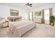 This light-filled bedroom is decorated with neutral colors, elegant art, and stylish furniture at 4932 St James St, Winter Haven, FL 33881