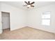 Bright bedroom with carpeted flooring, a ceiling fan, a window with natural light, and a closet at 4932 St James St, Winter Haven, FL 33881