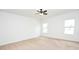 Spacious bedroom with a ceiling fan and carpeted floors, with windows offering natural light at 4932 St James St, Winter Haven, FL 33881