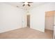 Bedroom featuring neutral carpet, a ceiling fan, and a walk-in closet for storage and convenience at 4932 St James St, Winter Haven, FL 33881