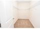 Walk-in closet with wire shelving, providing ample storage space in a neutral color scheme at 4932 St James St, Winter Haven, FL 33881