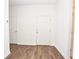 Clean entryway featuring wood-look floors, a front door, and a doorway leading to other parts of the home at 4932 St James St, Winter Haven, FL 33881
