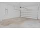 Unfinished garage space with a concrete floor, a sectional door, and ample potential for storage or customization at 4932 St James St, Winter Haven, FL 33881