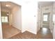 A hallway that has wood-look flooring transitions to carpet, with views of the living room and other rooms at 4932 St James St, Winter Haven, FL 33881