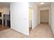 Hallway view with new appliances, washer/dryer, and doorways that connect different areas of the house at 4932 St James St, Winter Haven, FL 33881