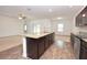 Spacious kitchen with granite counters, a center island, and an open view to the living room at 4932 St James St, Winter Haven, FL 33881