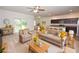 Comfortably furnished living room with coordinated decor, flowing into the kitchen with bar stool seating and outdoor views at 4932 St James St, Winter Haven, FL 33881