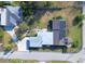 Aerial view of a home with solar panels, lush landscaping, and a carport at 495 King St, Haines City, FL 33844