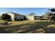 A shot of the house's backyard, highlighting ample yard space and an enclosed, screened-in porch area at 495 King St, Haines City, FL 33844