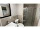 Bathroom featuring a glass shower, modern sink, and stylish wallpaper at 495 King St, Haines City, FL 33844