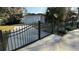 Gated driveway leading to a white brick house with a garage at 495 King St, Haines City, FL 33844