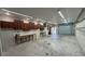 Spacious garage interior with built-in shelves, ample workspace, and overhead lighting for projects at 495 King St, Haines City, FL 33844