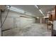 Spacious garage interior with built-in shelves, ample workspace, and overhead lighting for projects at 495 King St, Haines City, FL 33844