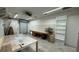 Spacious garage interior with built-in shelves, ample workspace, and overhead lighting for projects at 495 King St, Haines City, FL 33844