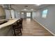 Open-concept living area with dining space, hardwood flooring, and natural light at 495 King St, Haines City, FL 33844