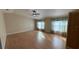 Spacious main bedroom with two windows, ceiling fan and light wood flooring at 495 King St, Haines City, FL 33844
