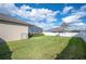 Well-maintained backyard with lush green grass and partial view of the screened-in patio at 5012 Ridgefield Ln, Lakeland, FL 33812