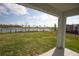 A view of the backyard and lake at 5062 Foxglove Cir, Lakeland, FL 33811
