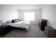 Bright bedroom features plush carpet, a large window, and a modern platform bed at 5062 Foxglove Cir, Lakeland, FL 33811