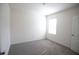 This bedroom features neutral carpeting and natural light from a single window at 5062 Foxglove Cir, Lakeland, FL 33811
