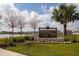 Hawthorne Ranch community sign with stone base, landscaping, and a view of the lake and homes at 5062 Foxglove Cir, Lakeland, FL 33811