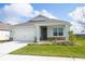 Charming single-story home featuring a well-manicured lawn and an attached two-car garage at 5062 Foxglove Cir, Lakeland, FL 33811